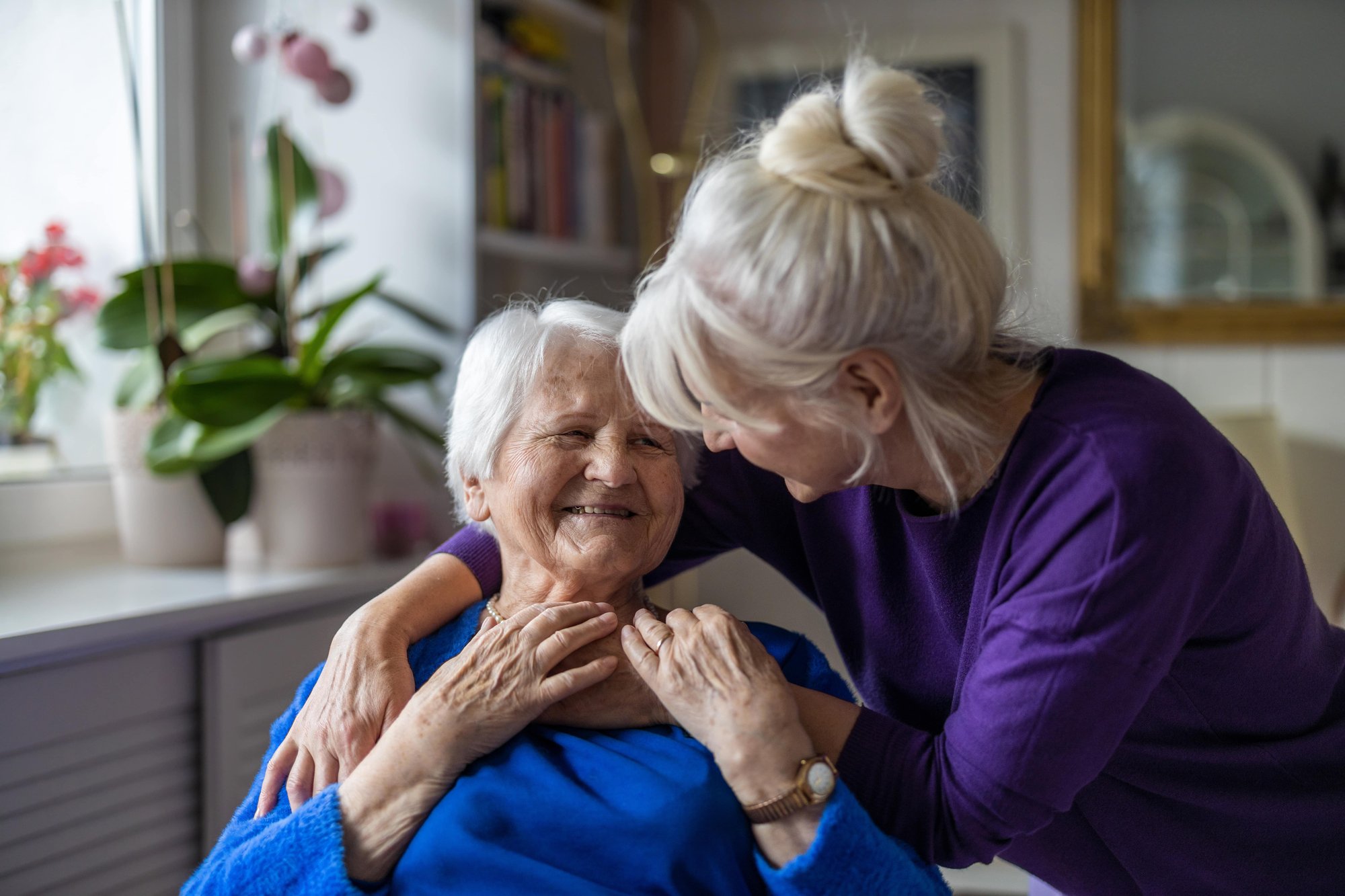 Woman hugging her elderly mother