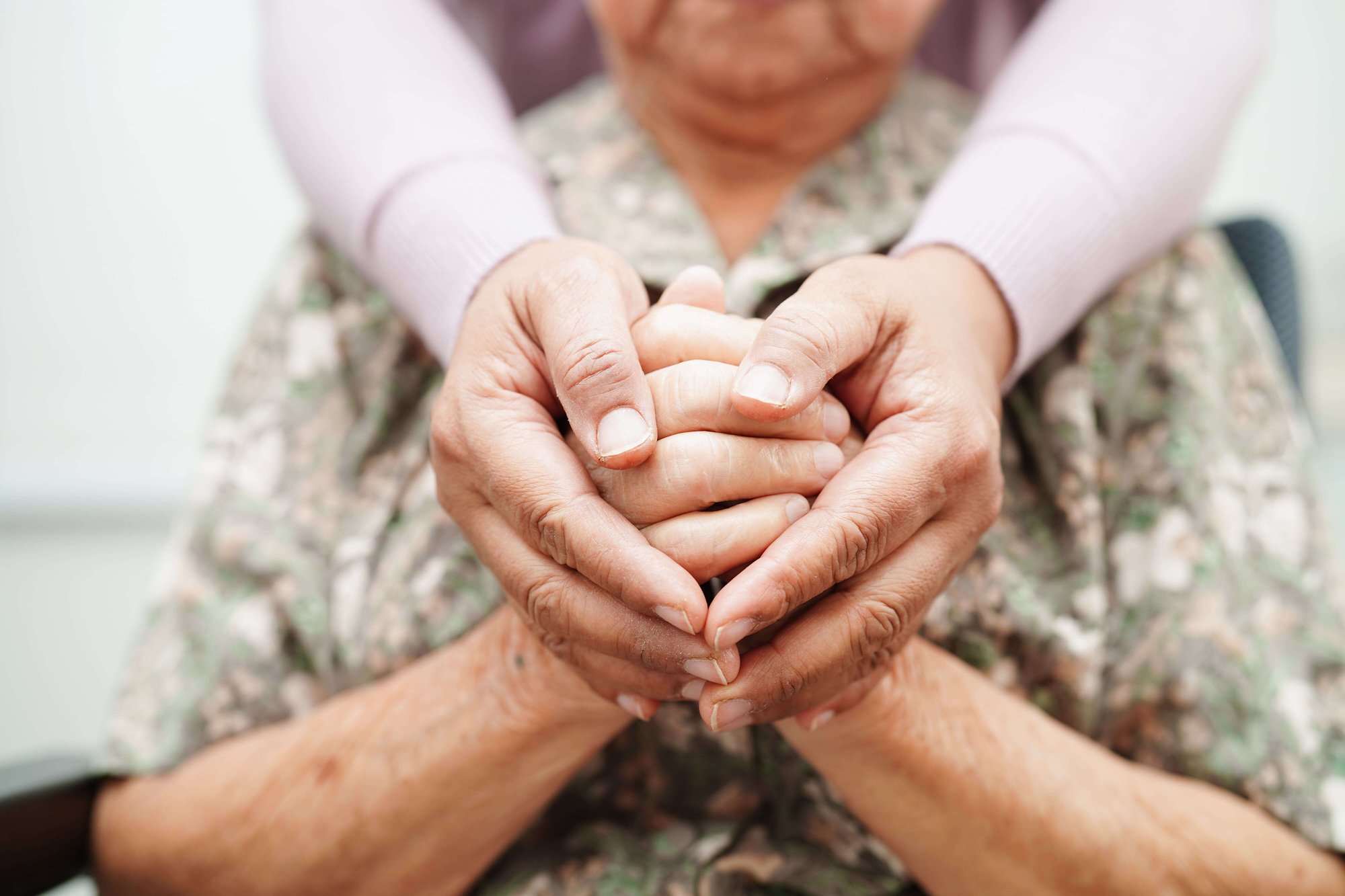 Caregiver holding hands