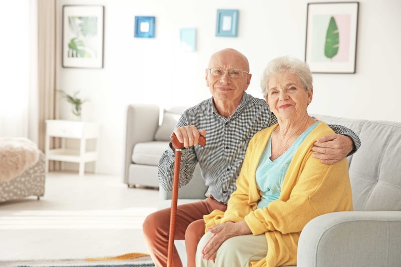 Senior couple sitting on couch in living room