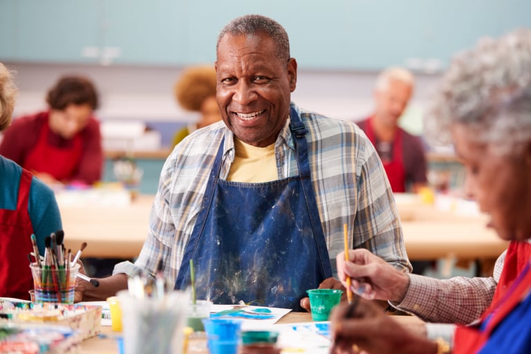 Portrait of a senior man attending an art class in a community center