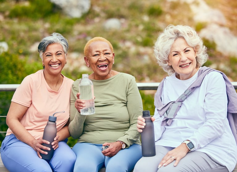 Senior women drinking water in outdoor activity together for health