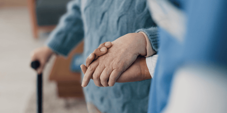 Holding hands, help with elderly person and caregiver in nursing home