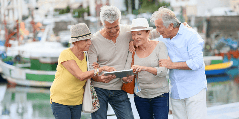 Senior couples looking at map on traveling journey