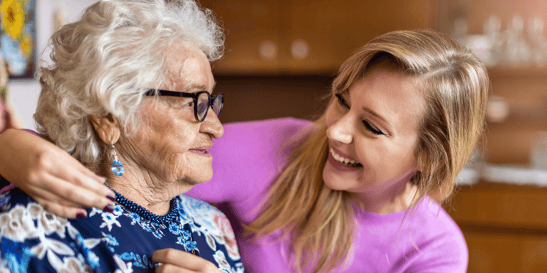 A young woman spending time with her elderly grandmother at home