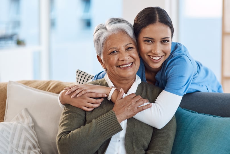 Senior living Patient with caretaker hugging