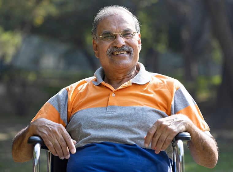 man in wheelchair smiling outside